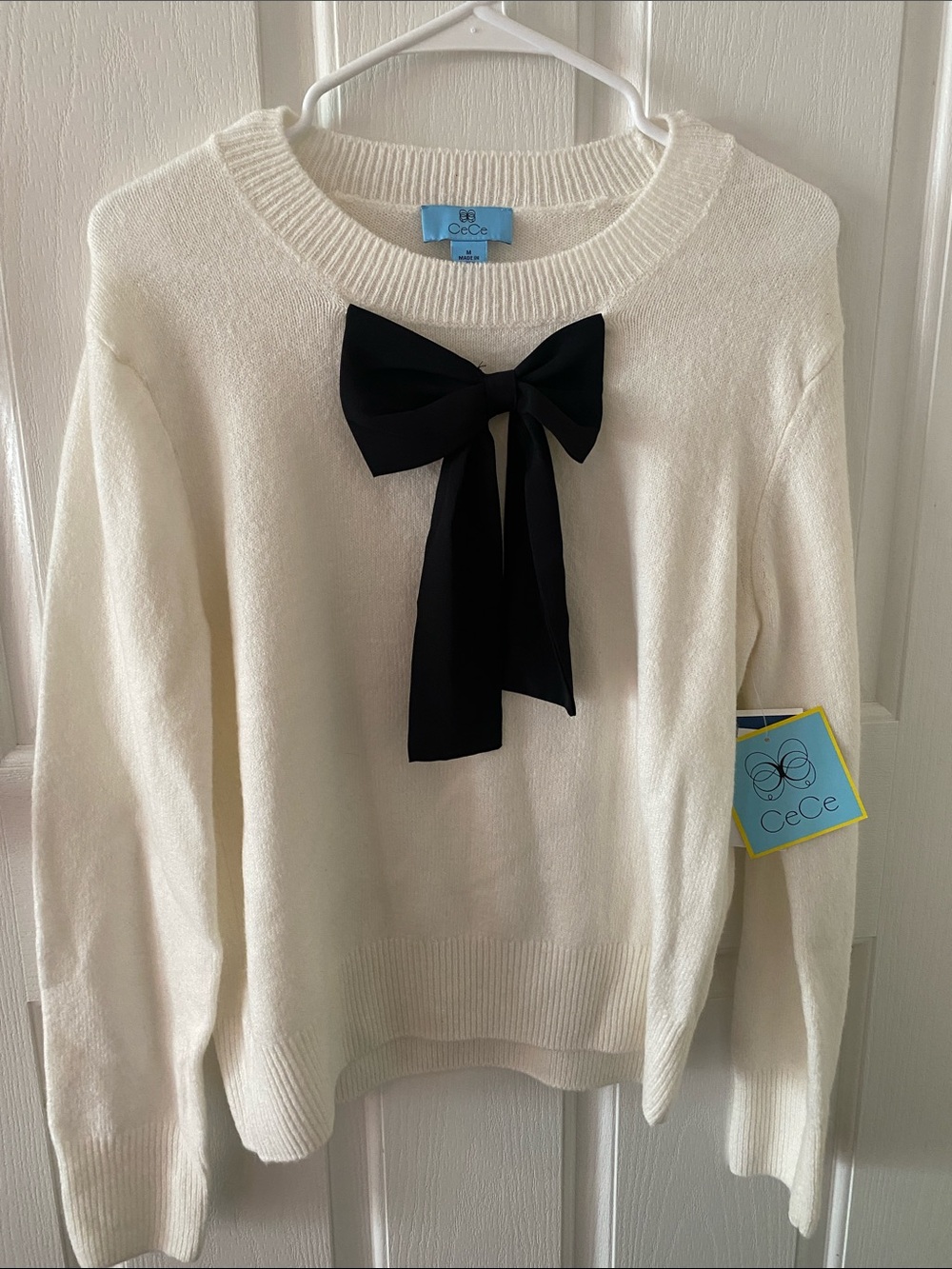 CeCe Ivory Crewneck Sweater with Black Bow Detail